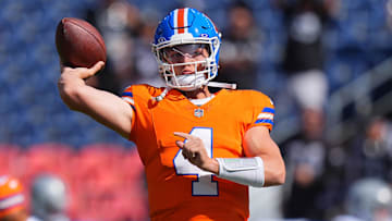 Denver Broncos quarterback Zach Wilson (4) warms up before the game against the Las Vegas Raiders at Empower Field at Mile High.