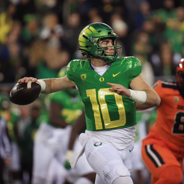 Oregon quarterback Bo Nix throws downfield against Oregon State on Nov. 24, 2023