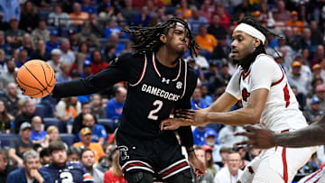 South Carolina guard Zachary Davis (2) passes the as Arkansas forward Jonas Aidoo (9) defends during a NCAA college basketball first round game at the men’s Southeastern Conference Tournament Wednesday, March 12, 2025, in Nashville, Tenn.