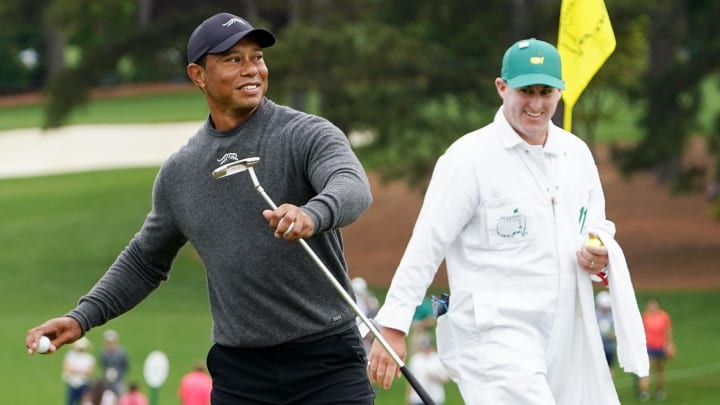 Apr 9, 2024; Augusta, Georgia, USA; Tiger Woods throws a ball to a patron from the no. 9 green.