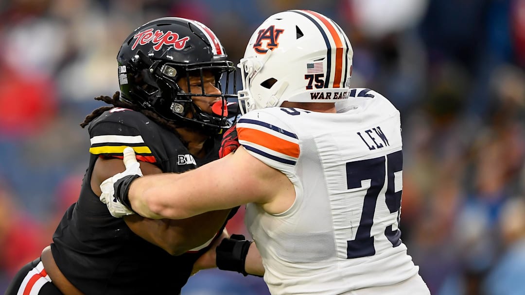 Dec 30, 2023; Nashville, TN, USA;  Maryland Terrapins defensive lineman Christian Teague (91) rushes as Auburn Tigers offensive lineman Connor Lew (75) defends during the second half at Nissan Stadium. Mandatory Credit: Steve Roberts-Imagn Images