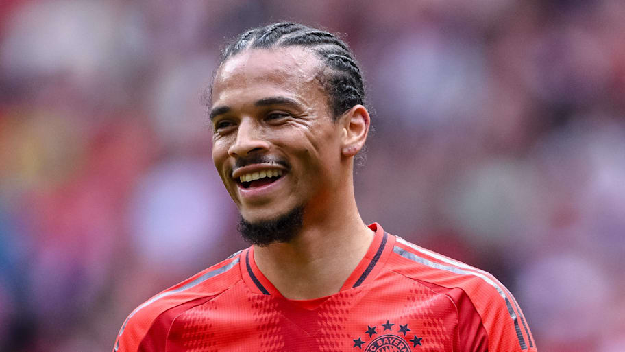 Leroy Sané smiling in a Bayern Munich kit