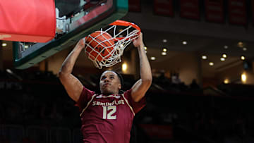 Jan 8, 2025; Coral Gables, Florida, USA; Florida State Seminoles forward Malique Ewin (12) dunks against the Miami Hurricanes during the first half at Watsco Center. Mandatory Credit: Sam Navarro-Imagn Images