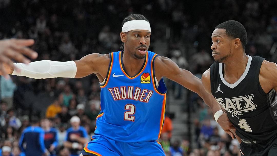 Mar 2, 2025; San Antonio, Texas, USA;  San Antonio Spurs guard De'Aaron Fox (4) dribbles against Oklahoma City Thunder guard Shai Gilgeous-Alexander (2) in the first half at Frost Bank Center. Mandatory Credit: Daniel Dunn-Imagn Images