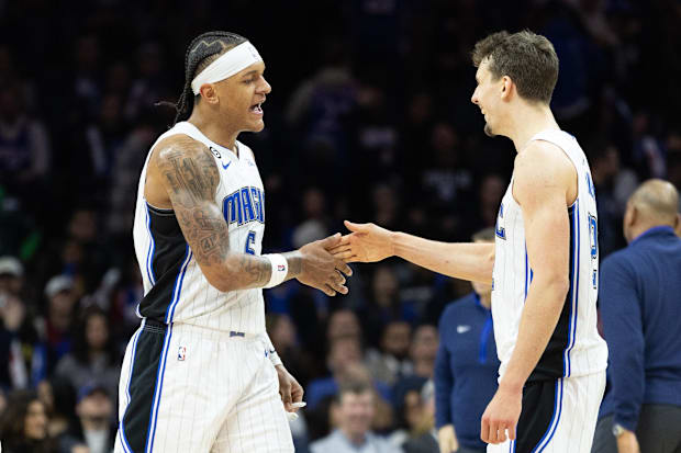 Orlando Magic forward Paolo Banchero (5) and forward Franz Wagner (22) celebrate a score against the Philadelphia 76ers