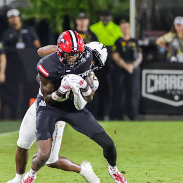 Aug 28, 2025; Orlando, Florida, USA; Jacksonville State Gamecocks wide receiver Deondre Johnson (11) is tackled by UCF Knights defensive back Jayden Bellamy (29) during the second quarter at Acrisure Bounce House. Mandatory Credit: Mike Watters-Imagn Images
