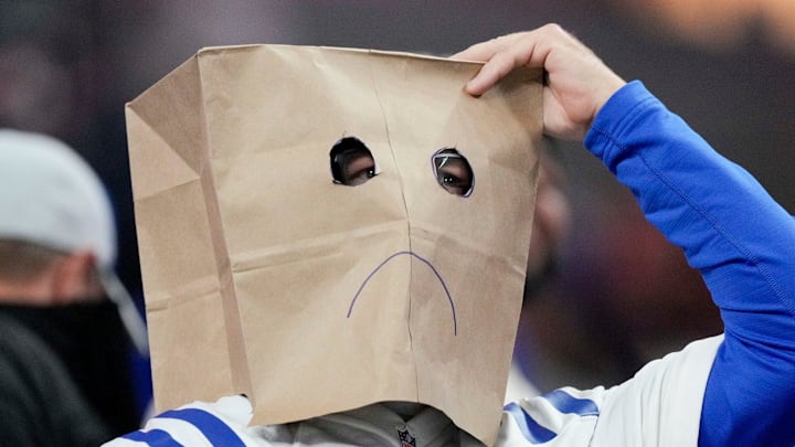 A Indianapolis Colts fan wears a sad paper bag mask Tuesday, Dec. 27, 2022, during a game against the Los Angeles Chargers at Lucas Oil Stadium in Indianapolis.