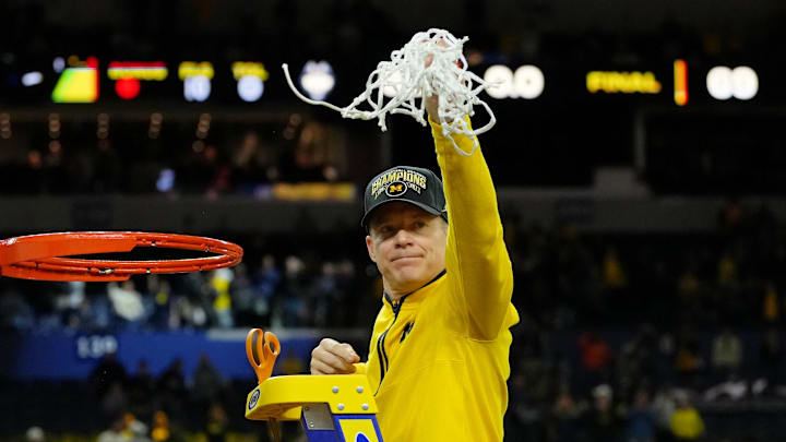 Apr 6, 2026; Indianapolis, IN, USA; Michigan Wolverines head coach Dusty May waves to fans after cutting the net after their win against the UConn Huskies in the national championship of the Final Four of the men's 2026 NCAA Tournament between the  and the Michigan Wolverines at Lucas Oil Stadium. Mandatory Credit: Bob Donnan-Imagn Images