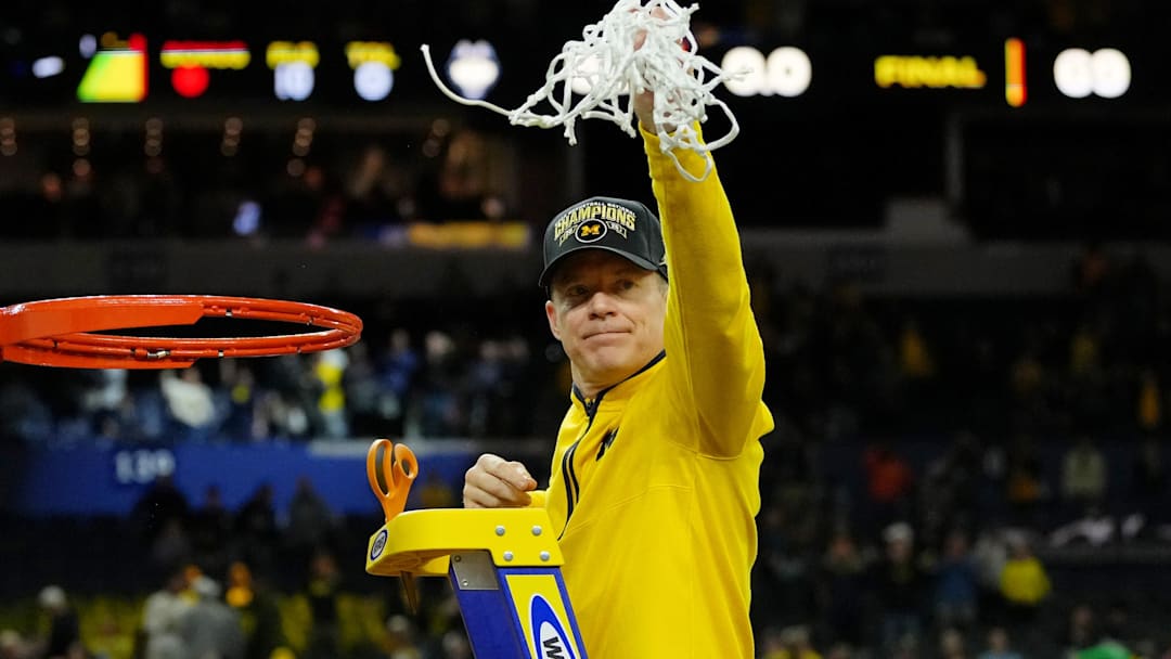 Apr 6, 2026; Indianapolis, IN, USA; Michigan Wolverines head coach Dusty May waves to fans after cutting the net after their win against the UConn Huskies in the national championship of the Final Four of the men's 2026 NCAA Tournament between the  and the Michigan Wolverines at Lucas Oil Stadium. Mandatory Credit: Bob Donnan-Imagn Images