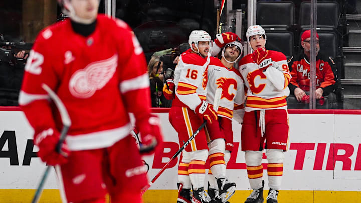 Mar 16, 2026; Detroit, Michigan, USA; Calgary Flames right wing Matt Coronato (27) celebrates his goal with teammates during the second period at Little Caesars Arena. Mandatory Credit: Tim Fuller-Imagn Images
