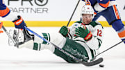 Apr 4, 2025; Elmont, New York, USA;  Minnesota Wild left wing Matt Boldy (12) chases the puck after falling down in the third period against the New York Islanders at UBS Arena. Mandatory Credit: Wendell Cruz-Imagn Images
