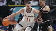 March 11, 2024; Las Vegas, NV, USA; Saint Mary's Gaels center Mitchell Saxen (11) dribbles the basketball against Santa Clara Broncos guard Jake Ensminger (44) during the second half in the semifinals of the WCC Basketball Championship at Orleans Arena. Mandatory Credit: Kyle Terada-Imagn Images