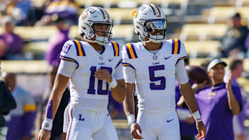 Nov 25, 2023; Baton Rouge, Louisiana, USA;  LSU Tigers quarterback Jayden Daniels (5) and  quarterback Rickie Collins (10) during warmups before the game against the Texas A&M Aggies at Tiger Stadium. Mandatory Credit: Stephen Lew-Imagn Images