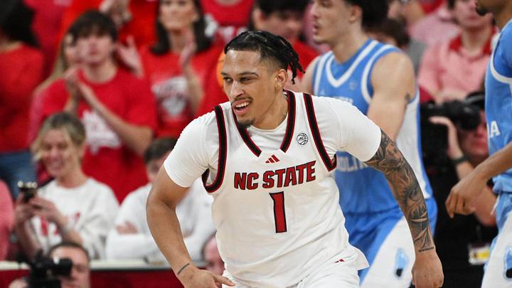 Feb 17, 2026; Raleigh, North Carolina, USA; NC State Wolfpack forward Darrion Williams (1) reacts after scoring against the North Carolina Tar Heels during the second half at Lenovo Center. Mandatory Credit: Zachary Taft-Imagn Images