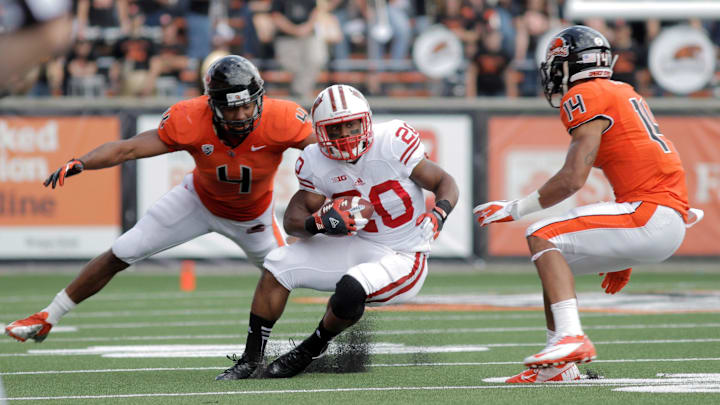 Sept. 8, 2012; Corvallis, OR, USA; Wisconsin Badgers running back James White (20) heads upfield between Oregon State Beavers defenders D.J. Welch (4) and Jordan Poyer during the second half at Reser Stadium. Sept. 8, 2012; Corvallis, OR, USA; Wisconsin Badgers running back James White (20) heads upfield between Oregon State Beavers defenders D.J. Welch (4) and Jordan Poyer during the second half at Reser Stadium.