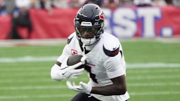 Oct 13, 2024; Foxborough, Massachusetts, USA; Houston Texans wide receiver Stefon Diggs (1) runs with the ball after making a catch against the New England Patriots during the first half at Gillette Stadium. Mandatory Credit: Gregory Fisher-Imagn Images