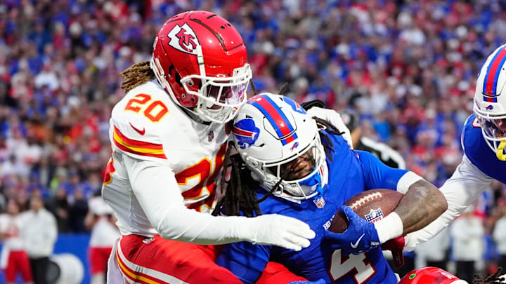 Nov 17, 2024; Orchard Park, New York, USA; Kansas City Chiefs safety Justin Reid (20) and Kansas City Chiefs linebacker Nick Bolton (32) tackle Buffalo Bills running back James Cook (4) during the first half at Highmark Stadium. Mandatory Credit: Gregory Fisher-Imagn Images