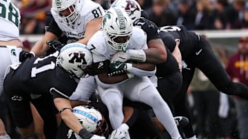 Nov 1, 2025; Minneapolis, Minnesota, USA; Michigan State Spartans running back Brandon Tullis (7) runs the ball against the Minnesota Golden Gophers during the first half at Huntington Bank Stadium. Mandatory Credit: Matt Krohn-Imagn Images