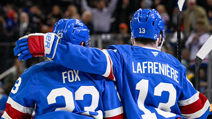 Apr 8, 2026; New York, New York, USA; New York Rangers defenseman Adam Fox (23) celebrates his goal with New York Rangers left wing Alexis Lafrenière (13) against the Buffalo Sabres during the second period at Madison Square Garden.
