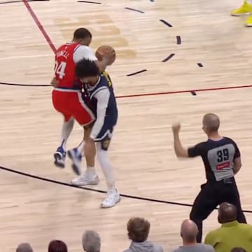 Los Angeles Clippers' Norman Powell is picked up by Denver Nuggets' Jamal Murray on April 22, 2025.