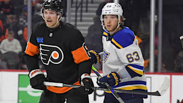 Oct 31, 2024; Philadelphia, Pennsylvania, USA; Philadelphia Flyers defenseman Travis Sanheim (6) and St. Louis Blues left wing Jake Neighbours (63) battle for position during the second period at Wells Fargo Center. Mandatory Credit: Eric Hartline-Imagn Images