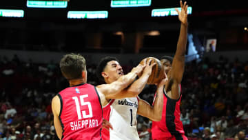 Jul 14, 2024; Las Vegas, NV, USA; Washington Wizards guard Johnny Davis (1) shoots against the defense of Houston Rockets guard Reed Sheppard (15) and guard Nate Williams (19) during the second quarter at Thomas & Mack Center. Mandatory Credit: Stephen R. Sylvanie-USA TODAY Sports