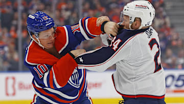 Oilers forward Trent Frederic fights Blue Jackets forward Mathieu Olivier.