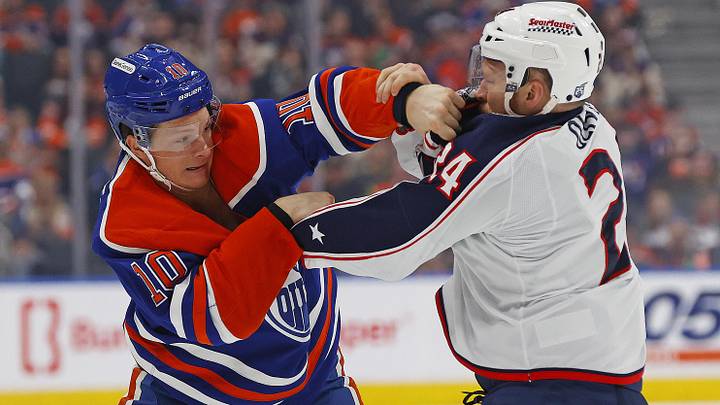 Oilers forward Trent Frederic fights Blue Jackets forward Mathieu Olivier.