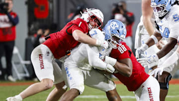 Nov 29, 2025; Raleigh, North Carolina, USA;  NC State Wolfpack linebacker Caden Fordham (1) and defensive end Isaiah Shirley (88) tackles North Carolina Tar Heels quarterback Gio Lopez (7) during the first half of the game against North Carolina Tar Heels at Carter-Finley Stadium.  Mandatory Credit: Jaylynn Nash-Imagn Images