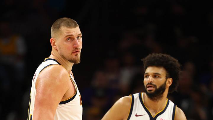 Nov 29, 2025; Phoenix, Arizona, USA; Denver Nuggets center Nikola Jokic (15) and guard Jamal Murray (27) against the Phoenix Suns at the Mortgage Matchup Center. Mandatory Credit: Mark J. Rebilas-Imagn Images