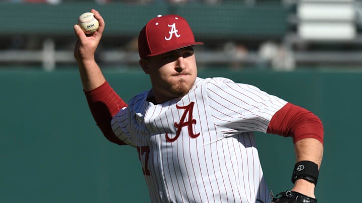 Feb 18, 2023; Bessemer, AL, USA; Alabama pitcher Ben Hess (27) fields a bunt and throws to first to record an out. The Crimson Tide faced Richmond in the season-opening series.

Sports Alabama Vs Richmond College Baseball