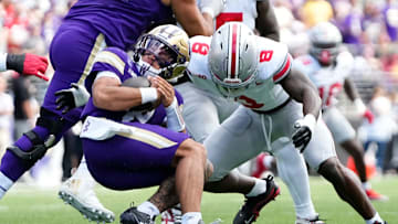 Ohio State Buckeyes linebacker Arvell Reese (8) tackles Washington Huskies quarterback Demond Williams Jr. (2) during the first half of the NCAA football game at Husky Stadium in Seattle on Sept. 27, 2025.