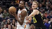 Nov 19, 2023; Salt Lake City, Utah, USA;  Phoenix Suns forward Kevin Durant (35) tries to get past Utah Jazz forward Lauri Markkanen (23) during the first quarter at Delta Center. Mandatory Credit: Chris Nicoll-Imagn Images