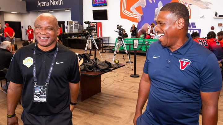 FHSAA Chief Executive Officer Craig Damon (left) and Vanguard head football coach Edwin Farmer share a laugh during the 2024 North Central Florida High School Football Media Day at the Alachua County Sports Complex in Gainesville, Fla. Wednesday July 17, 2024. On Wednesday, Damon spoke on the state's new NIL policy before the State Board of Education, before the policy was ratified.