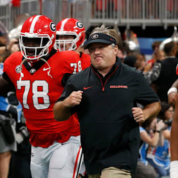 Georgia coach Kirby Smart leads his team onto the field before the start of the NCAA Aflac Kickoff Game in Atlanta, on Saturday, Aug. 31, 2024.