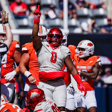 Oct 4, 2025; Tucson, Arizona, USA; Arizona Wildcats defensive lineman Deshawn McKnight (0) reacts after making a tackle against the Oklahoma State Cowboys during the second quarter at Arizona Stadium. Mandatory Credit: Aryanna Frank-Imagn Images