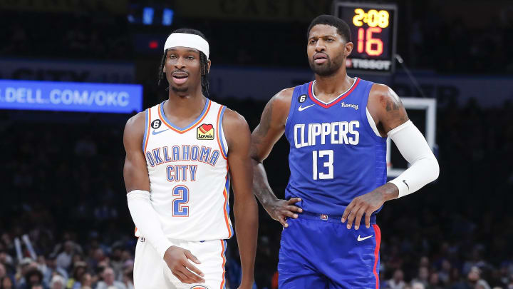 Oct 27, 2022; Oklahoma City, Oklahoma, USA; Oklahoma City Thunder guard Shai Gilgeous-Alexander (2) and LA Clippers guard Paul George (13) walks down the court during a time out during the first half at Paycom Center. Mandatory Credit: Alonzo Adams-USA TODAY Sports