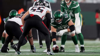 Dec 3, 2023; East Rutherford, NJ; New York Jets quarterback Trevor Siemian (14) lines up behind center Joe Tippmann (66) during the fourth quarter against the Atlanta Falcons at MetLife Stadium. 