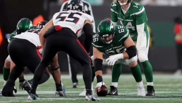 Dec 3, 2023; East Rutherford, NJ; New York Jets quarterback Trevor Siemian (14) lines up behind center Joe Tippmann (66) during the fourth quarter against the Atlanta Falcons at MetLife Stadium. 