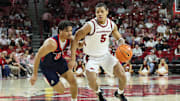 Nov 14, 2025; Fayetteville, Arkansas, USA; Arkansas Razorbacks guard Darius Acuff Jr (5) drives against Samford Bulldogs guard Isaiah Campbell-Finch (0) during the second half at Bud Walton Arena. Arkansas won 79-75.