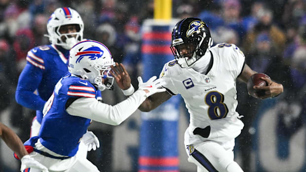 Baltimore Ravens quarterback Lamar Jackson (8) runs the ball during the first quarter against the Buffalo Bills.