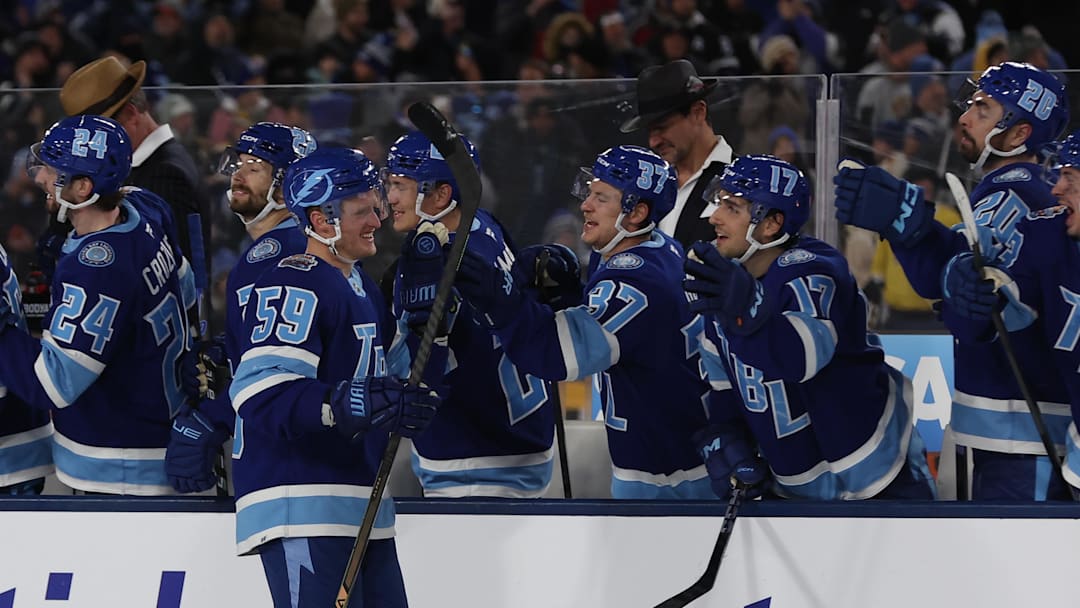 Feb 1, 2026; Tampa Bay, Florida, USA; Tampa Bay Lightning center Jake Guentzel (59) is congratulated by teammates after scoring a goal against the Boston Bruins during a shootout in the 2026 Stadium Series ice hockey game at Raymond James Stadium. Mandatory Credit: Kim Klement Neitzel-Imagn Images