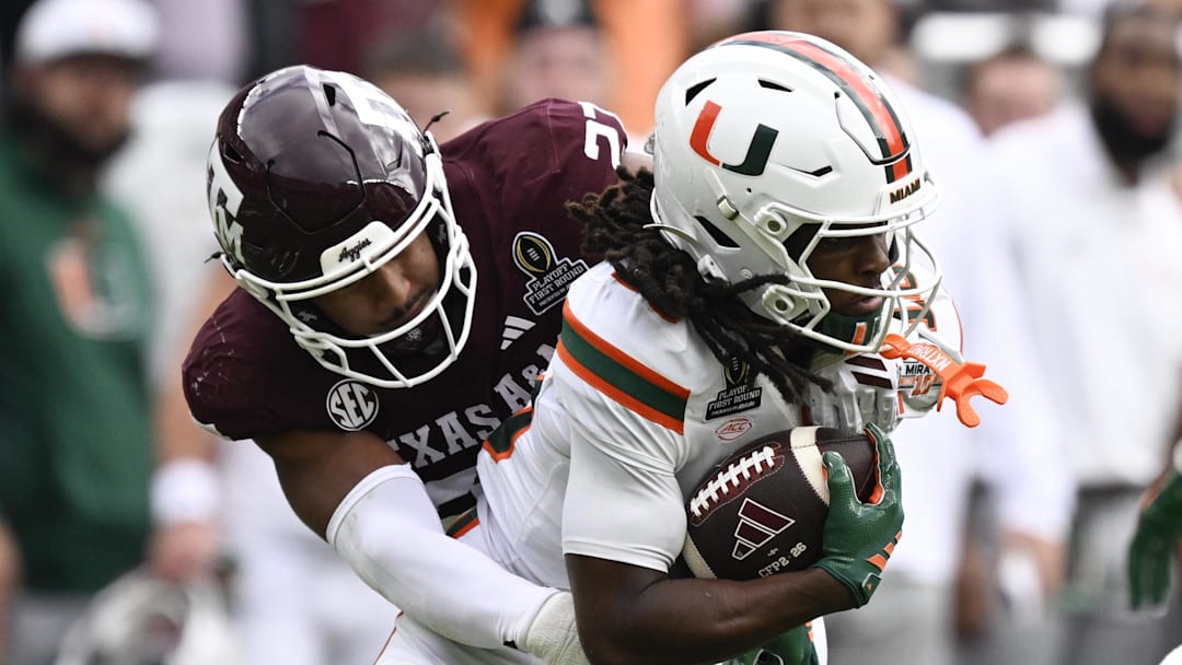 Dec 20, 2025; College Station, TX, USA; Miami Hurricanes wide receiver Malachi Toney (10) returns a punt and is tackled by Texas A&M Aggies linebacker Daymion Sanford (27) during first half of the first round game of the CFP National Playoff at Kyle Field. Mandatory Credit: Jerome Miron-Imagn Images