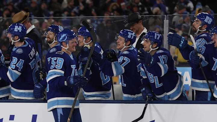 Feb 1, 2026; Tampa Bay, Florida, USA; Tampa Bay Lightning center Jake Guentzel (59) is congratulated by teammates after scoring a goal against the Boston Bruins during a shootout in the 2026 Stadium Series ice hockey game at Raymond James Stadium. Mandatory Credit: Kim Klement Neitzel-Imagn Images