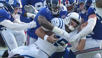 Dec 29, 2024; East Rutherford, New Jersey, USA; Indianapolis Colts quarterback Joe Flacco (15) is stopped by the Giants defense during the first quarter at MetLife Stadium. Mandatory Credit: Robert Deutsch-Imagn Images