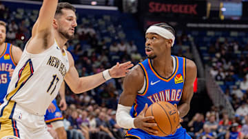 Thunder guard Shai Gilgeous-Alexander dribbles against Pelicans forward/center Karlo Matković in a recent game.