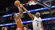 Mar 13, 2025; Nashville, TN, USA;  Texas Longhorns guard Tre Johnson (20) shoots over Texas A&M Aggies guard Zhuric Phelps (1) during the second half at Bridgestone Arena. Mandatory Credit: Steve Roberts-Imagn Images