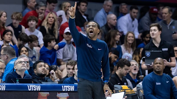 Duke Ble Devils associate head men's basketball coach Jai Lucas calls a play from the sideline.