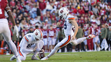 oNov 11, 2023; Fayetteville, Arkansas, USA;  Auburn Tigers place kicker Alex McPherson (38) kicks an extra point from holder Oscar Chapman (91) during the first quarter against the Arkansas Razorbacks at Donald W. Reynolds Razorback Stadium. Auburn won 48-10. Mandatory Credit: Brett Rojo-Imagn Images