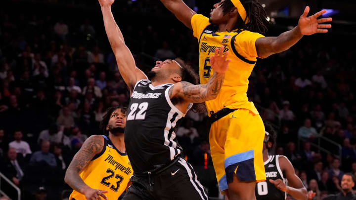 Mar 15, 2024; New York City, NY, USA;  Marquette Golden Eagles guard Tre Norman (5) blocks Providence Friars guard Devin Carter (22) during the second half at Madison Square Garden. Mandatory Credit: Robert Deutsch-USA TODAY Sports